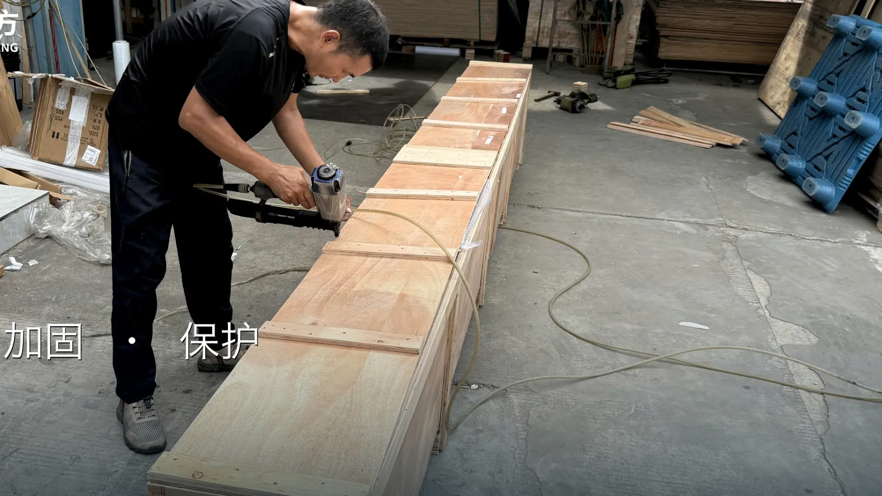 BuildCargo Logistics worker fastening a custom wooden crate