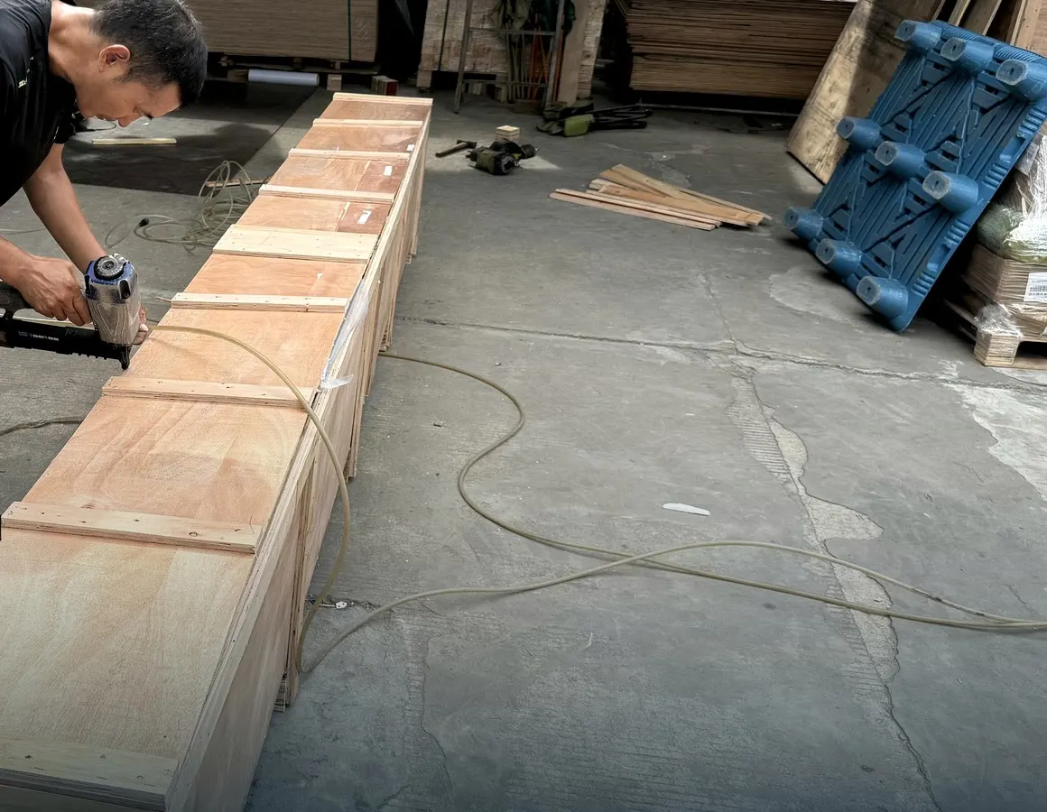 BuildCargo Logistics worker fastening a custom wooden shipping crate