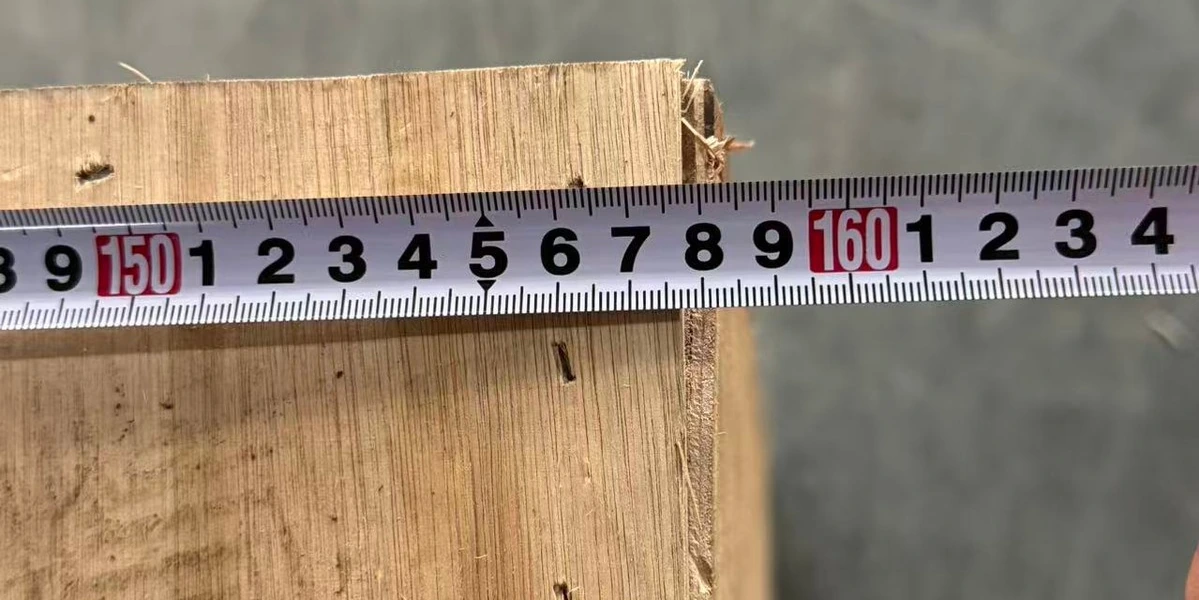 Ruler photograph alongside the length of an anonymized wooden crate